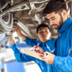 Two,Professional,Look,Technician,Inspecting,Car,Underbody,And,Suspension,System